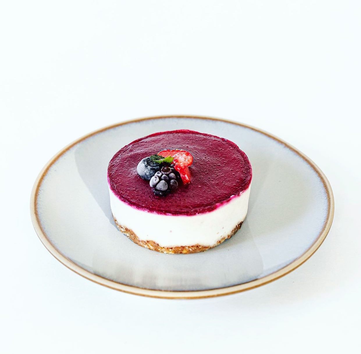 Elegant berry cheesecake on a rustic plate